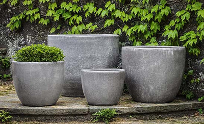 Grouping of 4 grey containers in front of vine