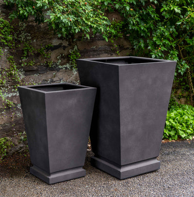 Set of 2 grey containers in front of stone wall