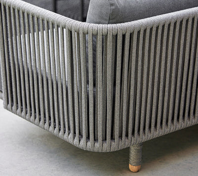 Close up of the back of a sofa with grey cushions