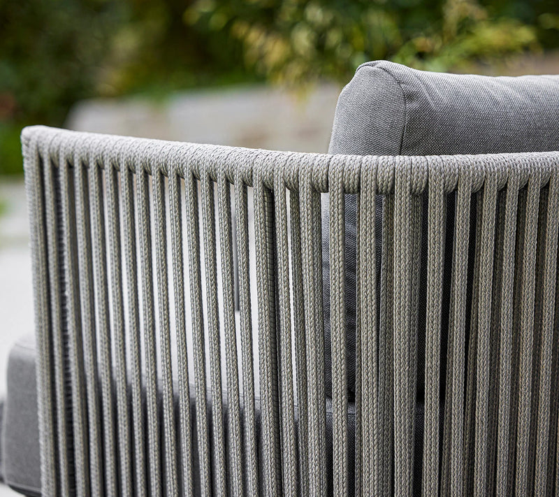 Close up of woven sofa with grey cushions