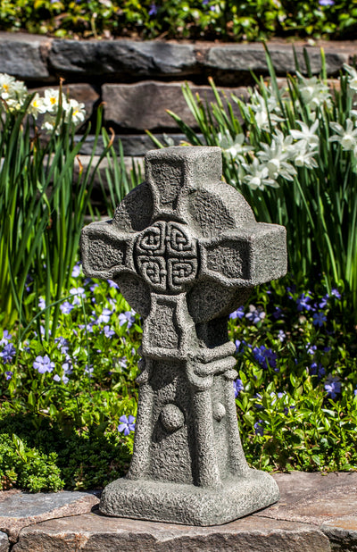 Gray Celtic cross on top of wall
