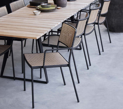 Dining set with a rectangular table and matching chairs on light grey patio