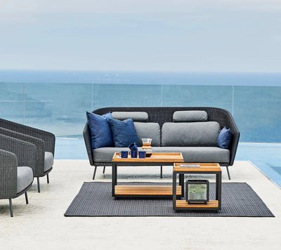 Outdoor sitting set with two coffee tables on gray rug