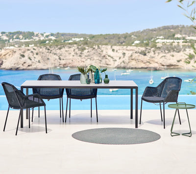 Dining set in front of body of water with boats