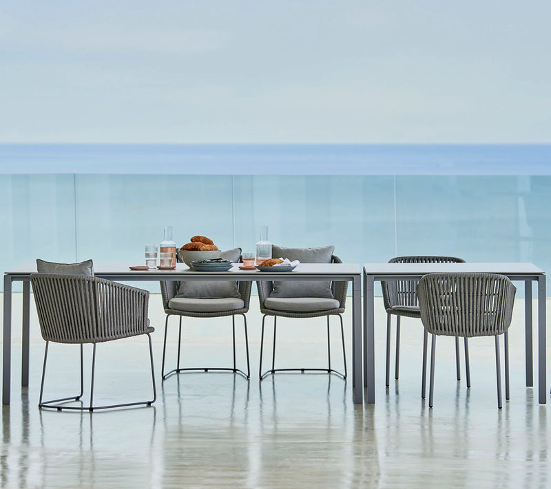 Grey dining set in front of ocean