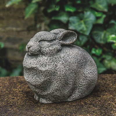Stylized bunny with closed eyes sitting on a wall