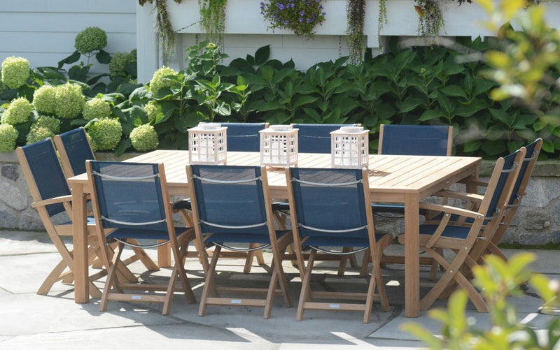 Teak table with chairs shown with white lanterns on the table