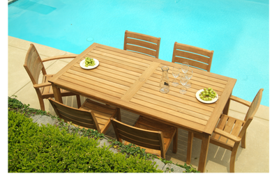 Rectangular teak table with six matching chairs by the pool