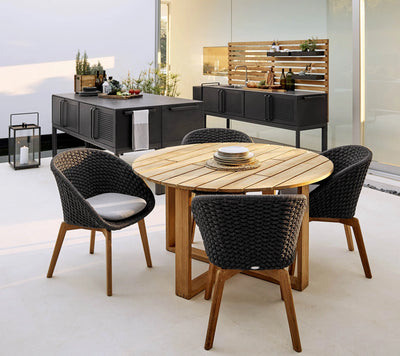 Dining set in front of outdoor kitchen on white floor