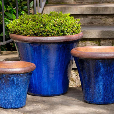 Grouping of 3 blue containers shown in front of steps