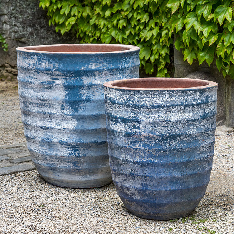 Set of 2 blue containers shown on gravel patio
