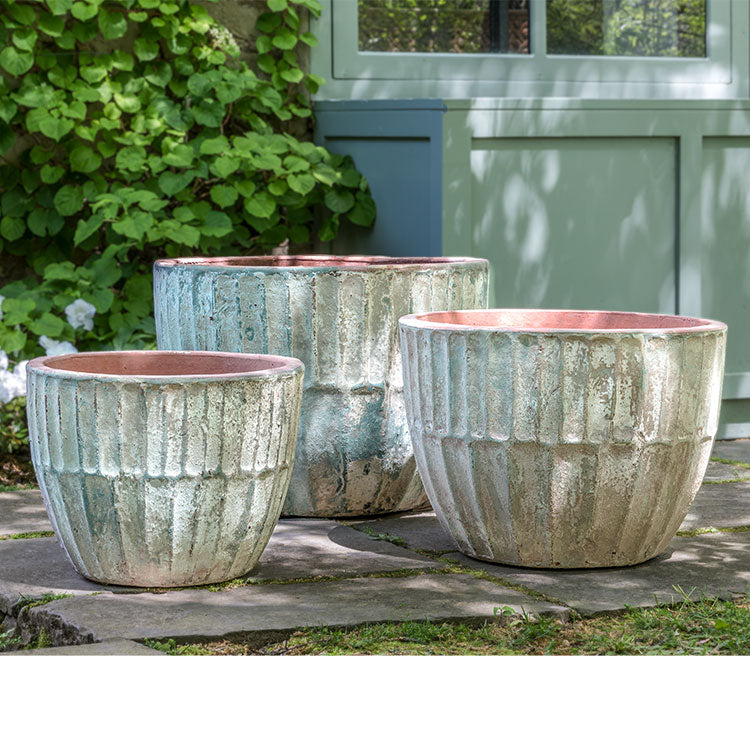 Grouping of 3 containers sitting on patio