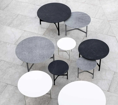Top view of different coffee tables in shades of black, gray and white