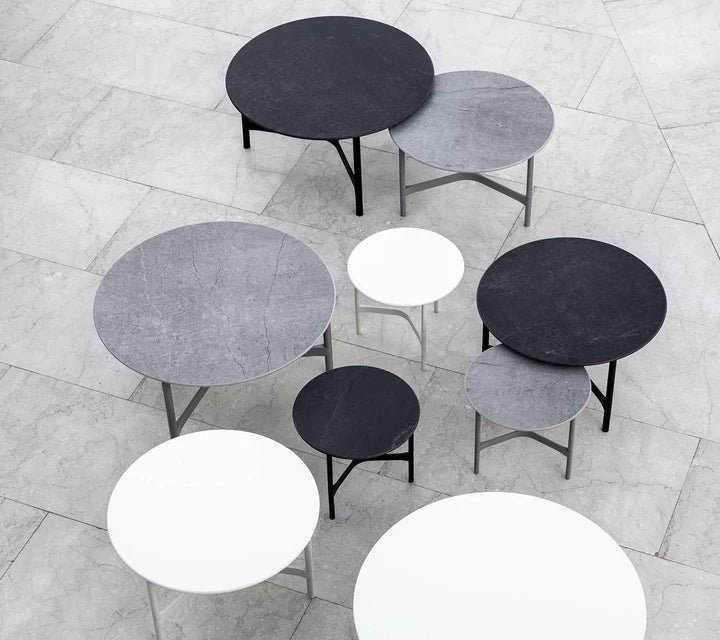 Top view of different coffee tables on gray terrace
