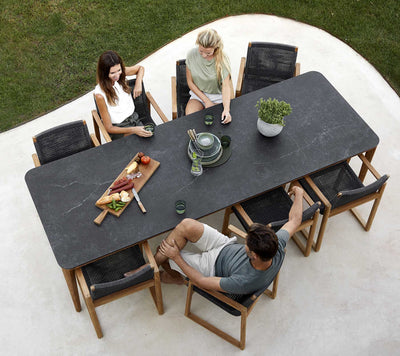 Top view of rectangular dining table with three people sitting
