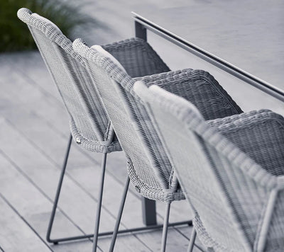Back view of gray armchairs on gray decking