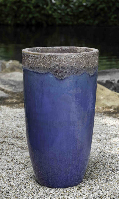 Tall blue container shown on gravel floor