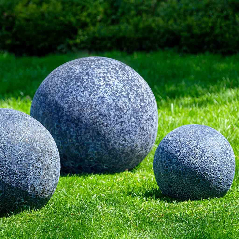Three blue Angkor spheres on grass
