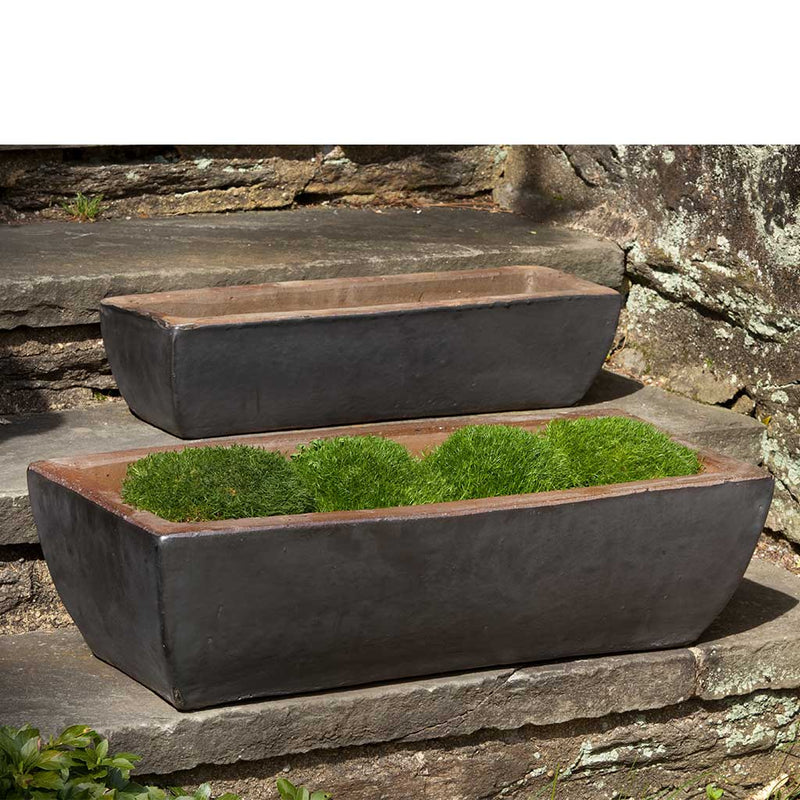 Two rectangular dark grey planters shown on stone steps