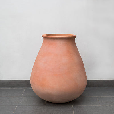 Terra cotta urn in front of wall