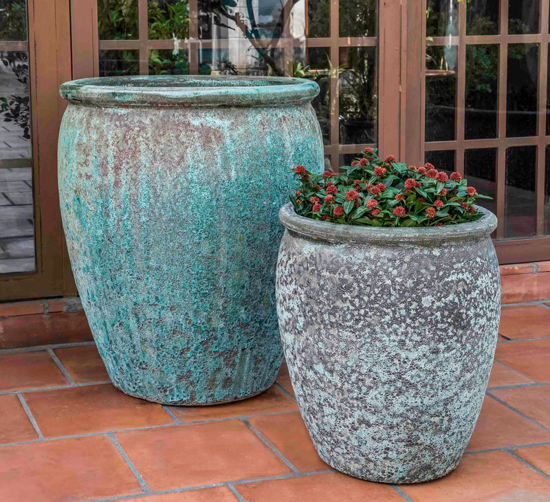 Set of 2 rustic containers in front of patio door