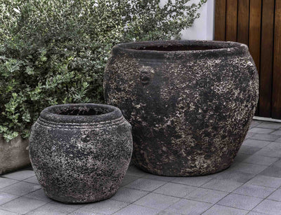 Set of 2 rustic containers in front of greenery