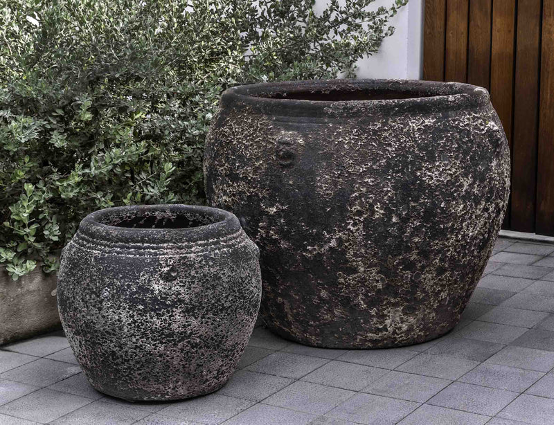 Set of 2 rustic containers in front of greenery
