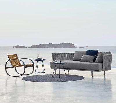 Set of outdoor furniture in front of the ocean