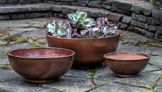 Grouping of 3 bowls of different sizes on stone floor