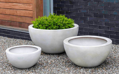 Grouping of 3 white containers on gravel