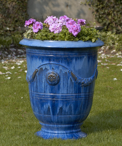 Blue classic urn planted with pink geraniums