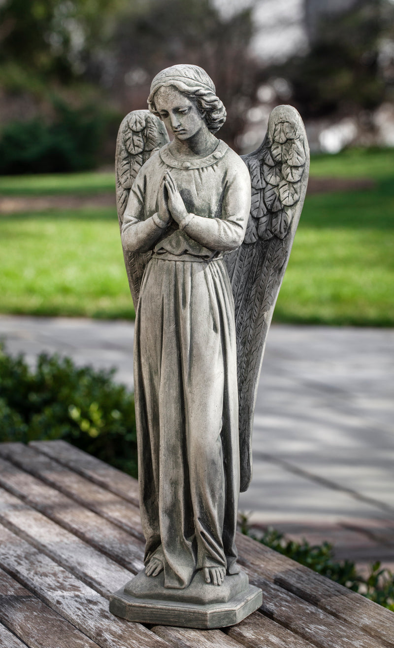 Standing angel praying with back wings