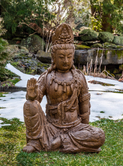 Sitting buddha with head dress with forearm resting on knee