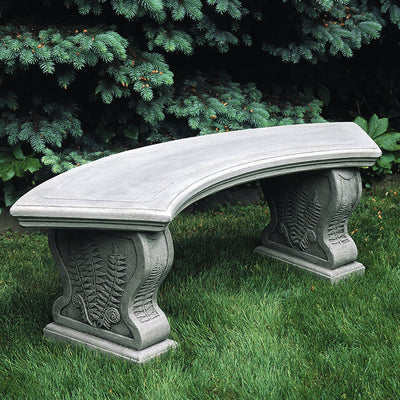 Curved grey cast stone bench with legs decorated with fern leaves