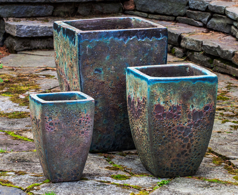 Grouping of 3 containers standing on stone floor