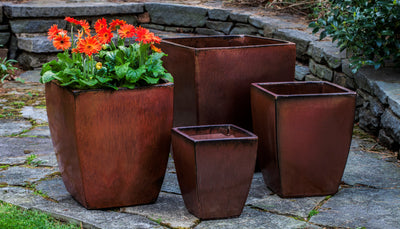 Grouping of 4 dark red containers on stone patio