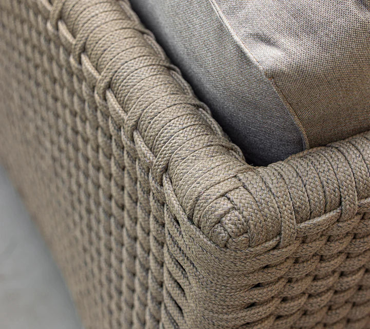 Close up of woven furniture with grey cushion