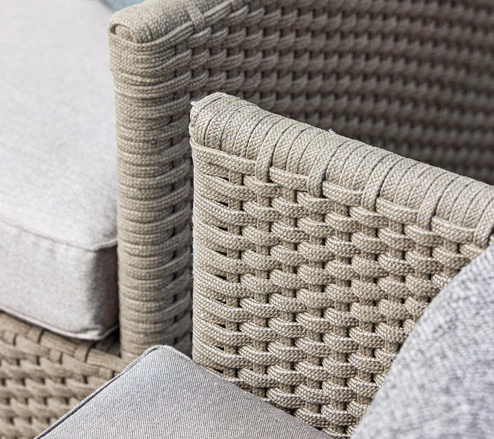 Close up of armchair with grey cushions