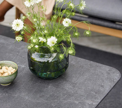 Top view of gray coffee table with vase of white flowers