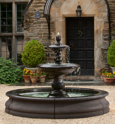 Two-tired black fountain with finial spout with water spilling into large round basin