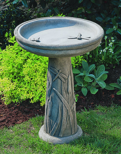 Round birdbath with dragonfly in bowl and along the stand