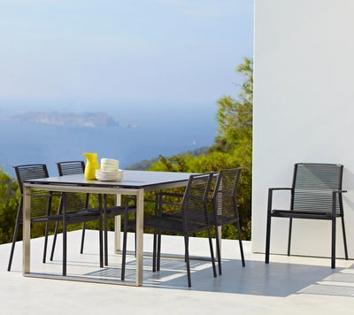 Dining set with five chairs overlooking the ocean