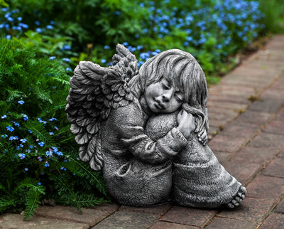 Small angel holding her knees in front of forget-me-not