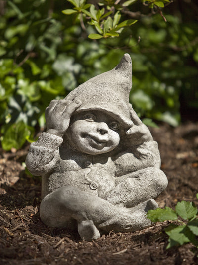 Little gnome sitting and playing with his hat