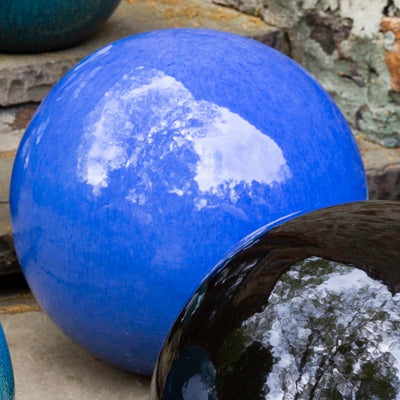 Bright blue glazed ceramic sphere close up