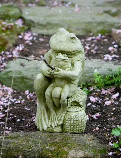 One green frog holding a little frog on lap and fishing