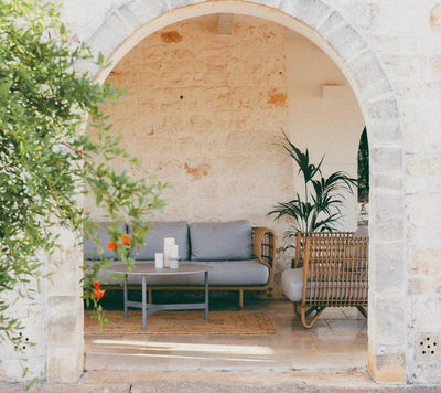 Grey sofa shown in an outdoor alcove