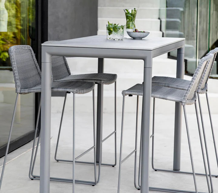 Gray bar set with one table and four chairs on a gray patio