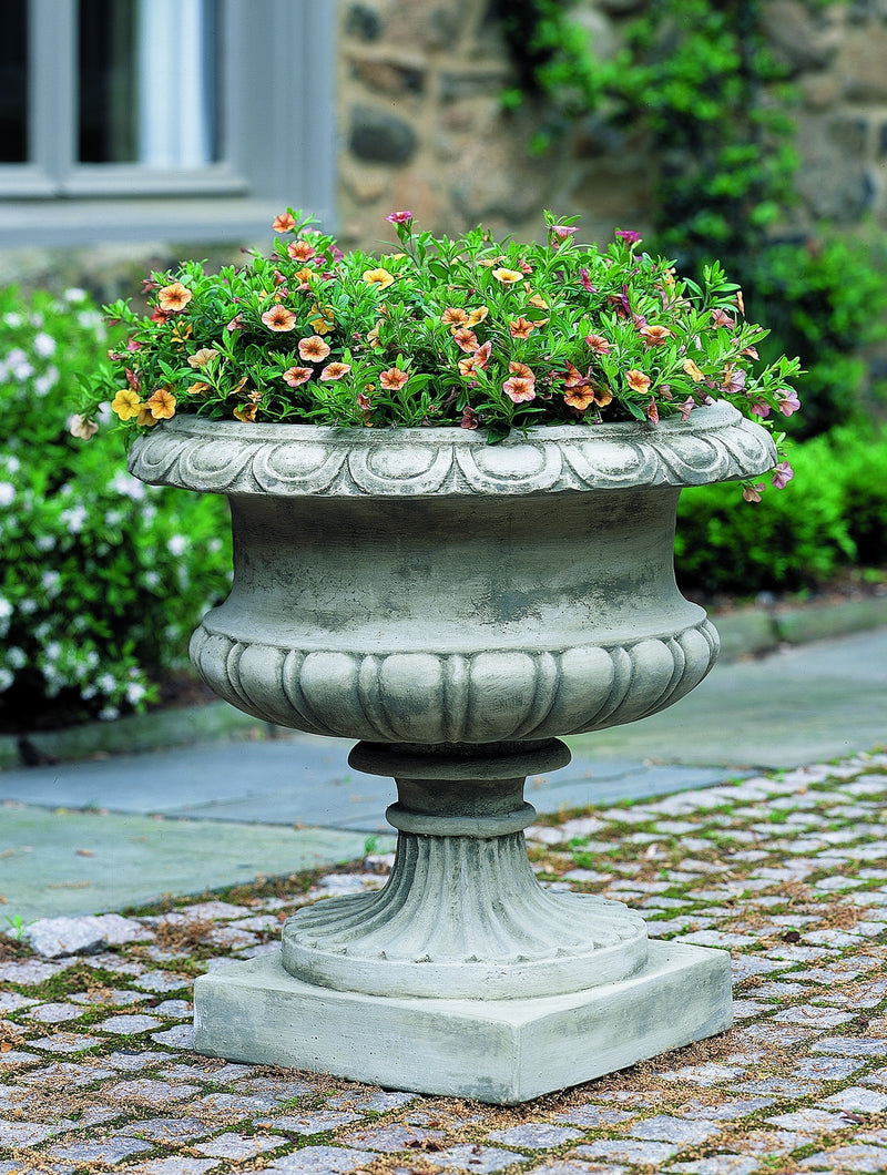 Classic urn planted with annuals on paver terrace