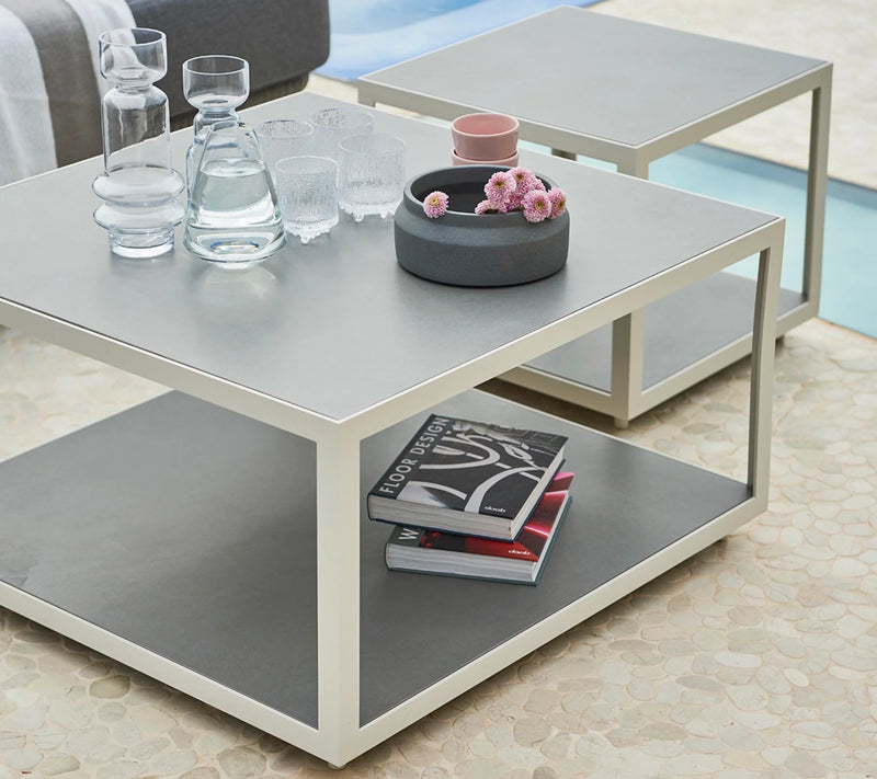 Gray coffee tables with glassware on top
